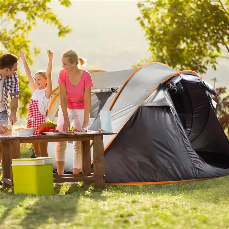 A family exploring the great outdoors with a self pop-up camping tent A family exploring the great outdoors with a self pop-up camping tent